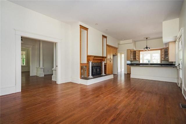 unfurnished living room with dark hardwood / wood-style floors and sink