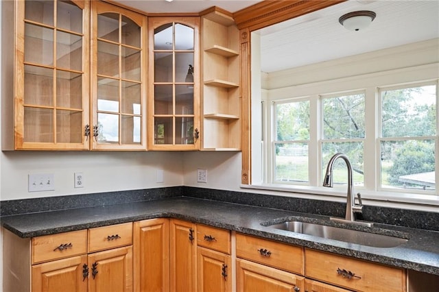 kitchen featuring sink and dark stone counters