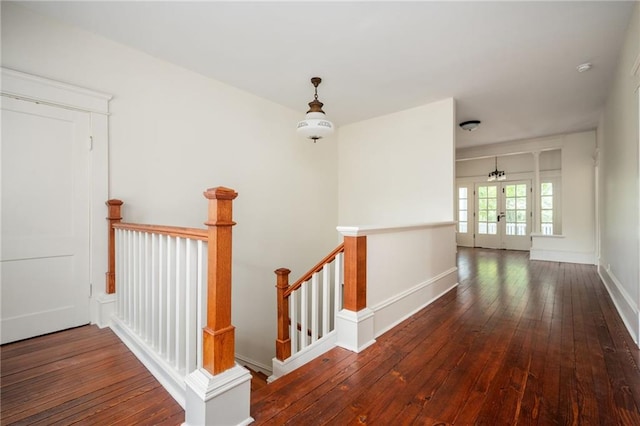 hallway with dark wood-type flooring and french doors