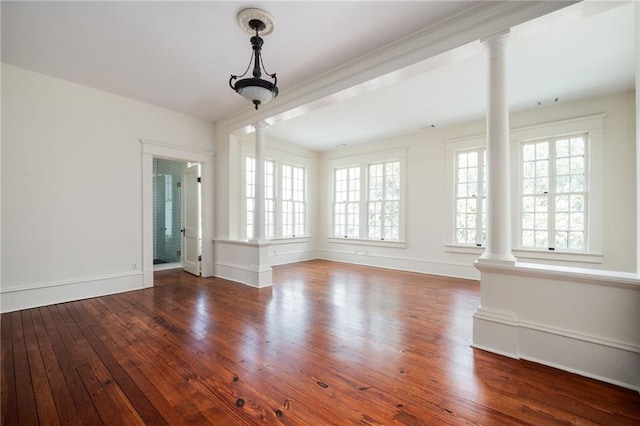 interior space with hardwood / wood-style floors and decorative columns