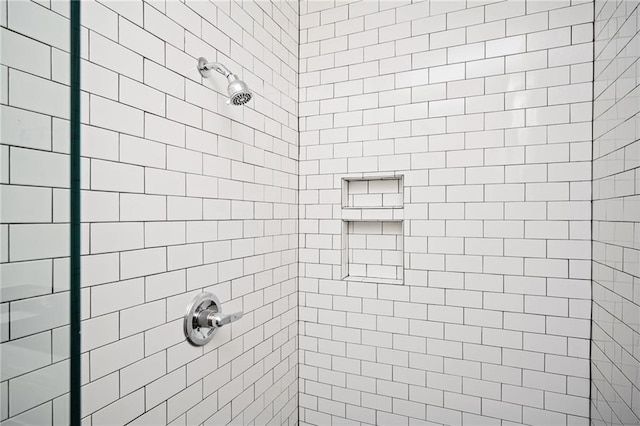 bathroom with a tile shower