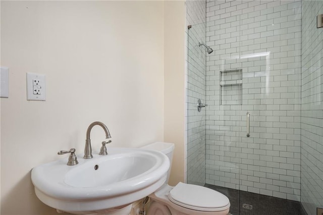 bathroom with walk in shower, toilet, and sink