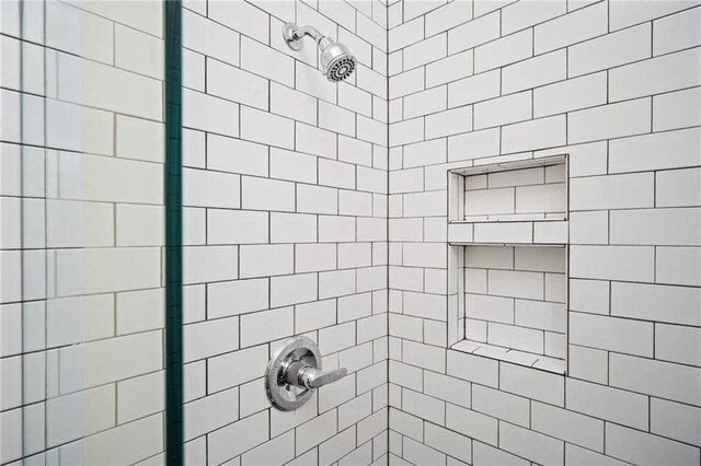 bathroom with tiled shower