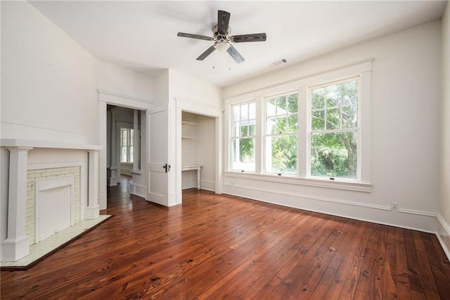 unfurnished living room featuring dark hardwood / wood-style flooring and ceiling fan