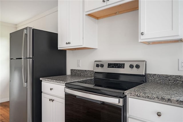 kitchen featuring white cabinetry, light stone counters, and appliances with stainless steel finishes