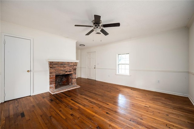 unfurnished living room with crown molding, a fireplace, dark hardwood / wood-style floors, and ceiling fan