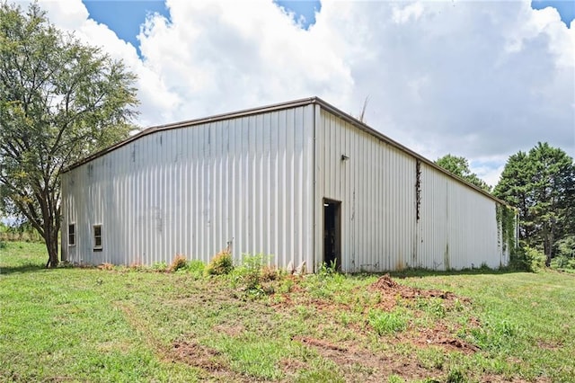 view of outbuilding with a yard