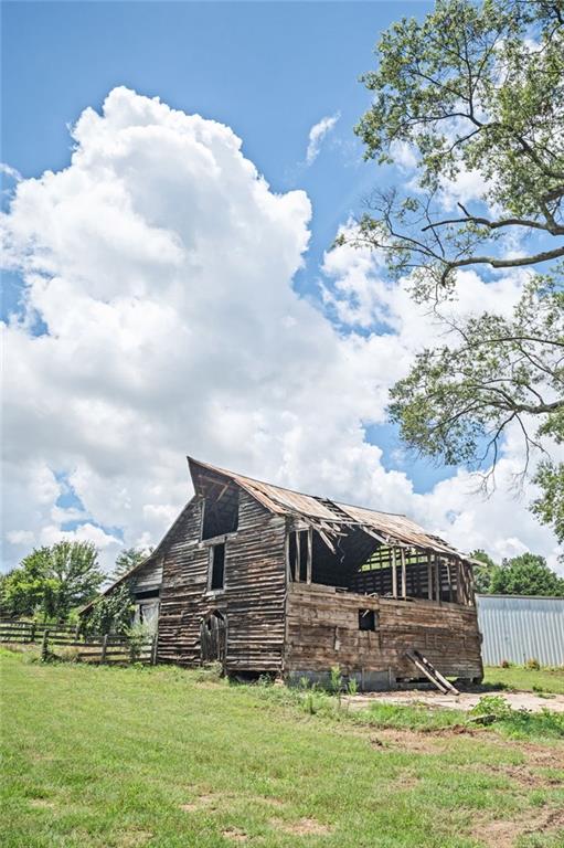 view of side of home with an outdoor structure and a lawn