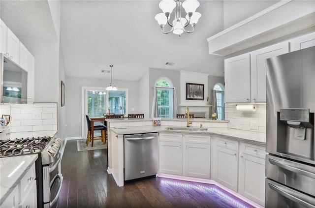1610 Trellis Xing, Alpharetta, GA 30004 - kitchen with stainless steel appliances, a chandelier, a peninsula, dark wood-style floors, and white cabinetry
