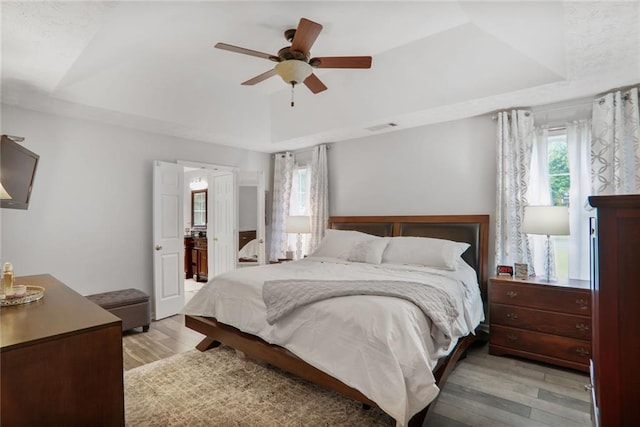 1610 Trellis Xing, Alpharetta, GA 30004 - bedroom with light wood finished floors, a raised ceiling, vaulted ceiling, and a ceiling fan