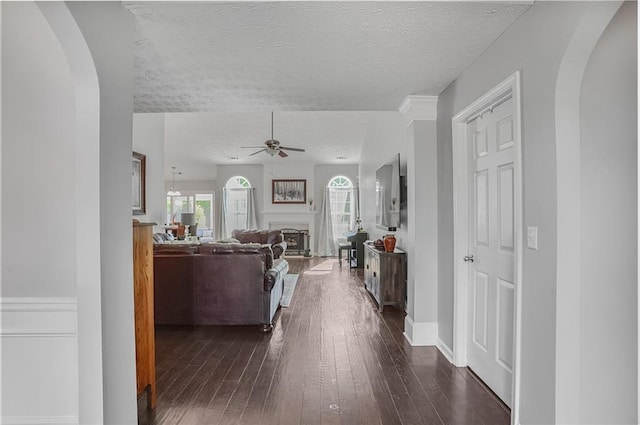 1610 Trellis Xing, Alpharetta, GA 30004 - living area with a ceiling fan, arched walkways, dark wood-type flooring, and a textured ceiling