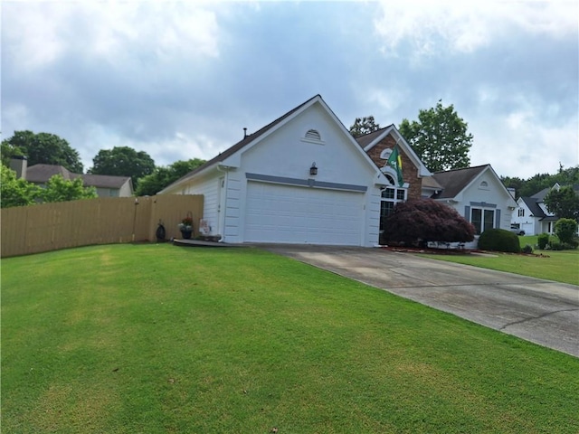 view of front facade featuring a front yard, fence, concrete driveway, an attached garage, and stucco siding