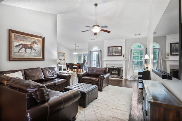 1610 Trellis Xing, Alpharetta, GA 30004 - living area featuring vaulted ceiling, ceiling fan, a fireplace with raised hearth, light wood finished floors, and healthy amount of natural light