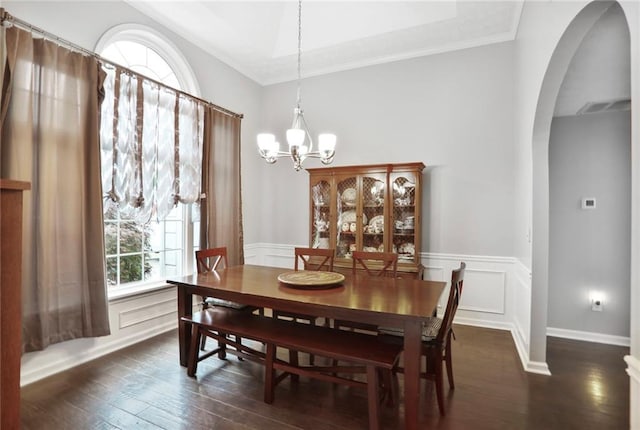 1610 Trellis Xing, Alpharetta, GA 30004 - dining room featuring arched walkways, a chandelier, dark wood-style floors, crown molding, and wainscoting