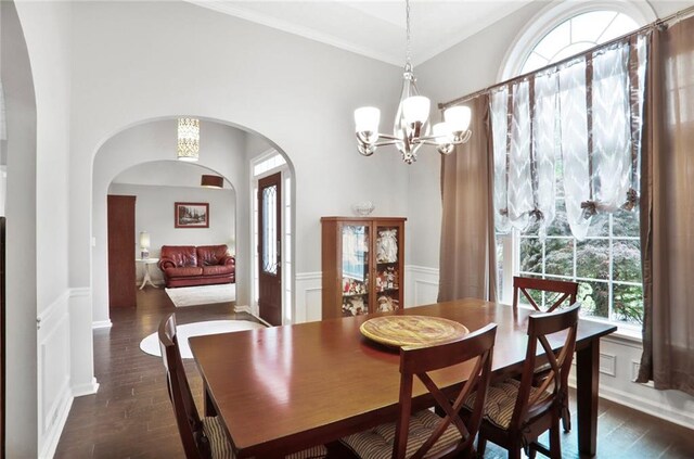 1610 Trellis Xing, Alpharetta, GA 30004 - dining room featuring healthy amount of natural light, a chandelier, dark wood finished floors, a decorative wall, and ornamental molding