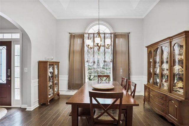 1610 Trellis Xing, Alpharetta, GA 30004 - dining area with arched walkways, a chandelier, dark wood finished floors, a decorative wall, and wainscoting
