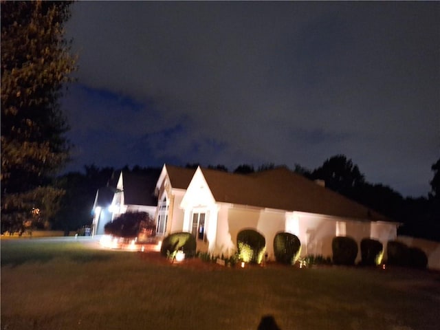 property exterior at twilight with stucco siding