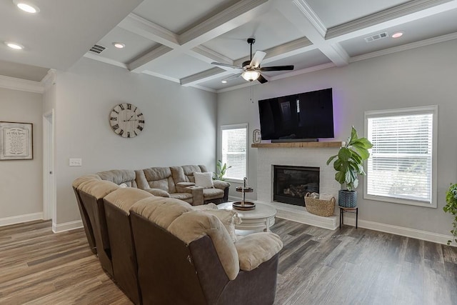 living room with coffered ceiling, dark wood-type flooring, and a fireplace