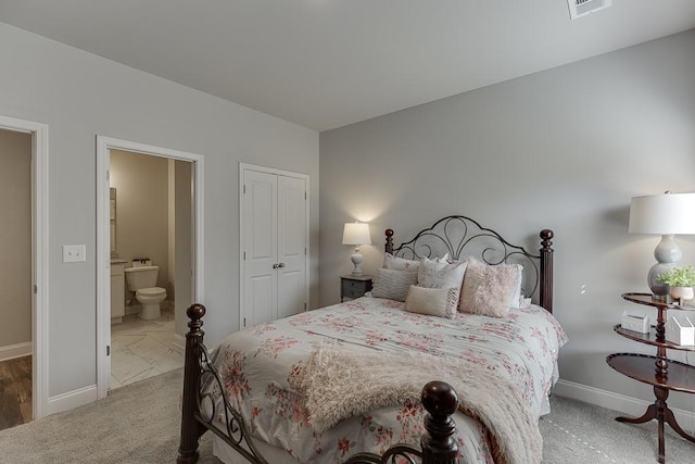 carpeted bedroom featuring connected bathroom