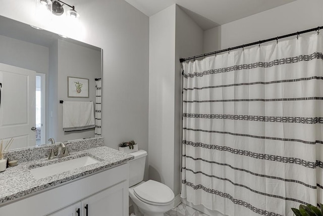 bathroom featuring vanity, toilet, and a shower with shower curtain