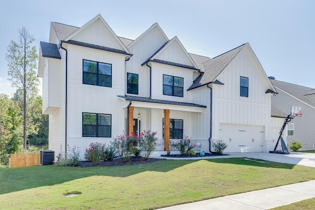 modern farmhouse style home with cooling unit, a garage, a front lawn, and covered porch