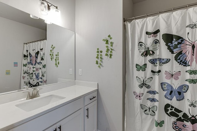 bathroom featuring vanity and a shower with shower curtain