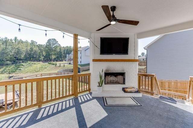 view of patio / terrace featuring an outdoor brick fireplace and ceiling fan