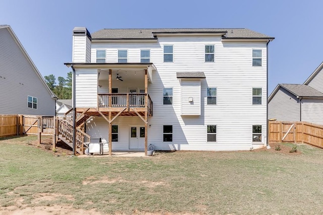 rear view of house with ceiling fan, a yard, and a patio