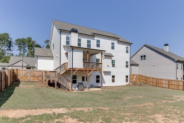 back of house with a yard and a patio area