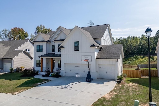 modern farmhouse featuring a garage and a front yard