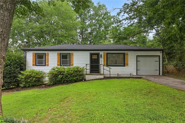 single story home featuring a front yard, concrete driveway, and an attached garage