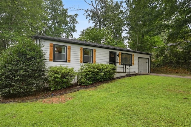 ranch-style home with a garage, a front lawn, and aphalt driveway