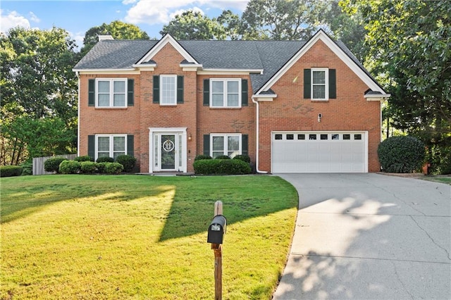 view of front of property with a garage and a front yard