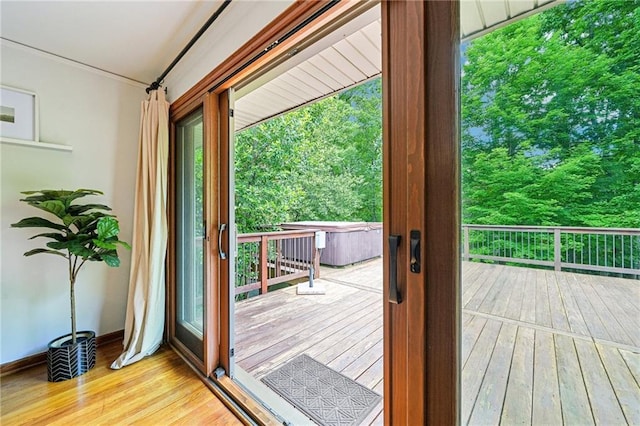 entryway with wood-type flooring, plenty of natural light, crown molding, and baseboards