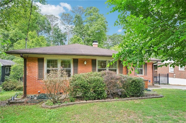 view of front of house with brick siding and a chimney