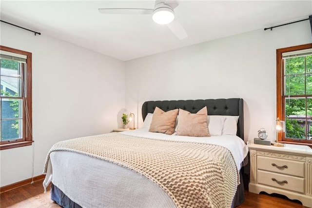 bedroom with wood finished floors, baseboards, and a ceiling fan