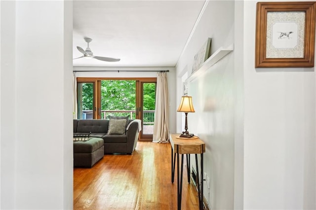 sitting room featuring wood finished floors and ceiling fan