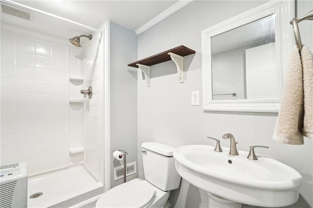 full bathroom featuring a shower stall, toilet, a sink, and ornamental molding