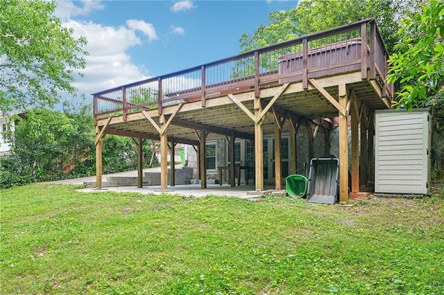 view of property's community featuring a wooden deck, a yard, and a patio