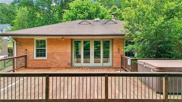wooden terrace with french doors and a hot tub