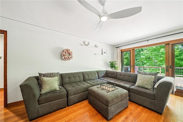living room featuring wood finished floors, healthy amount of natural light, and a ceiling fan