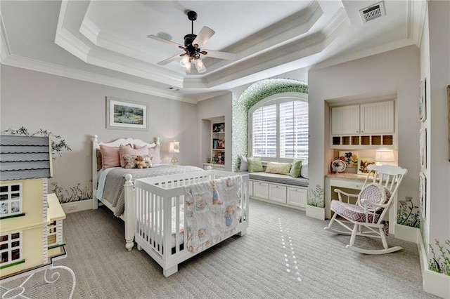 bedroom featuring visible vents, ornamental molding, light carpet, a raised ceiling, and a ceiling fan