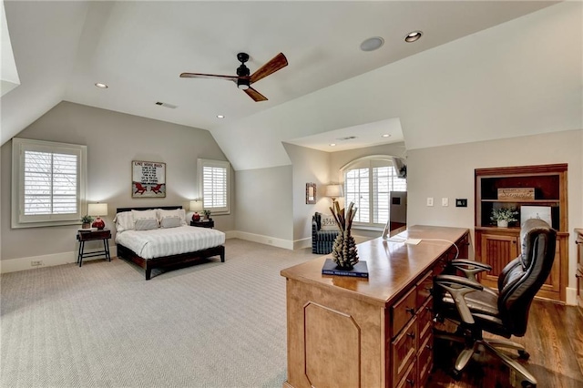 carpeted bedroom featuring vaulted ceiling, multiple windows, and visible vents