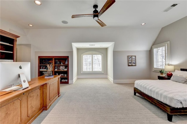 bedroom with lofted ceiling, multiple windows, visible vents, and light carpet