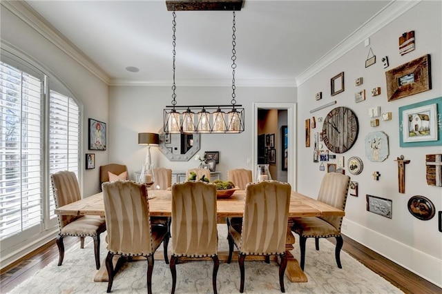 dining area featuring plenty of natural light, wood finished floors, and ornamental molding