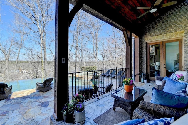 balcony with outdoor lounge area and ceiling fan