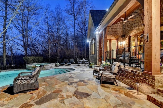 view of pool featuring a patio, a pool with connected hot tub, and ceiling fan