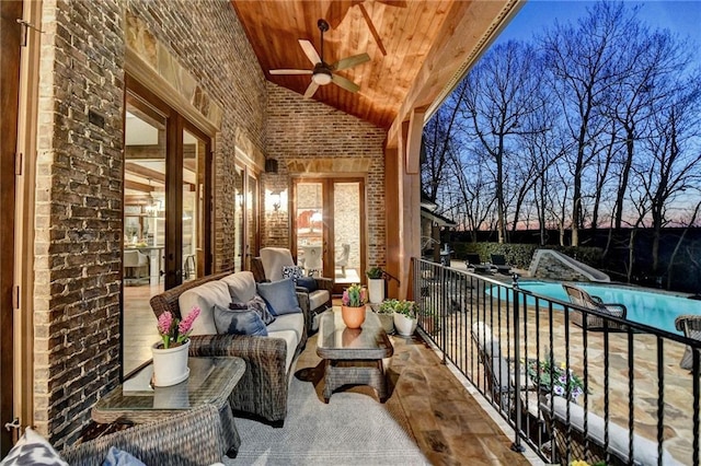 balcony featuring an outdoor hangout area, a ceiling fan, and a patio area