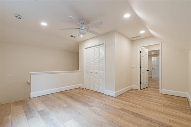 additional living space featuring recessed lighting, a ceiling fan, visible vents, vaulted ceiling, and light wood finished floors