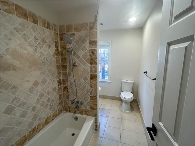 bathroom featuring shower / tub combination, tile patterned flooring, toilet, and baseboards